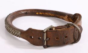 A late 19th/early 20th century brown leather dog collar with metal stud decoration, 65cm long.