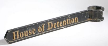 A 20th century English black & gold painted cast metal direction sign, 'House of Detention',