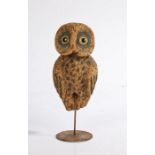 An early 20th century Folk Art cork decoy owl, with glass eyes, charred markings, associated