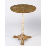 A composite occasional table, the 20th century drain cover circular top on Victorian cast iron base,