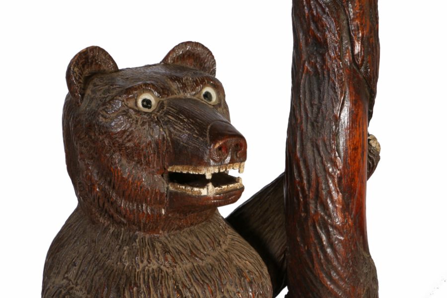 A Folk Art carved standing bear stick stand, the bear with wide eyes and an pen mouth holding onto a - Image 3 of 3