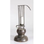 A 19th Century iron and wood 'stable' or 'birdcage' candlestick, with adjustable candle platform,
