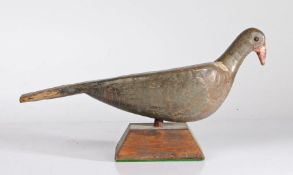 A late 19th/early 20th century painted wooden decoy pigeon, metal stud eyes, raised in later