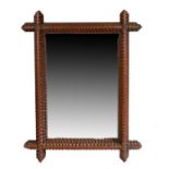 A 19th century Tramp Art rectangular mirror, the typical carved geometric frame of cruciform design,