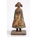 A late 19th century cast iron figural moneybox, in the form of a Dutch girl in traditional dress,