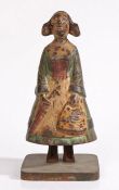 A late 19th century cast iron figural moneybox, in the form of a Dutch girl in traditional dress,