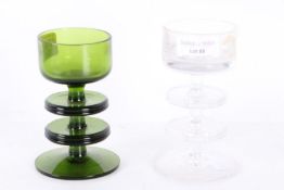 Two mid 20th century Sheringham pattern glass candle holders one in green the other clear,