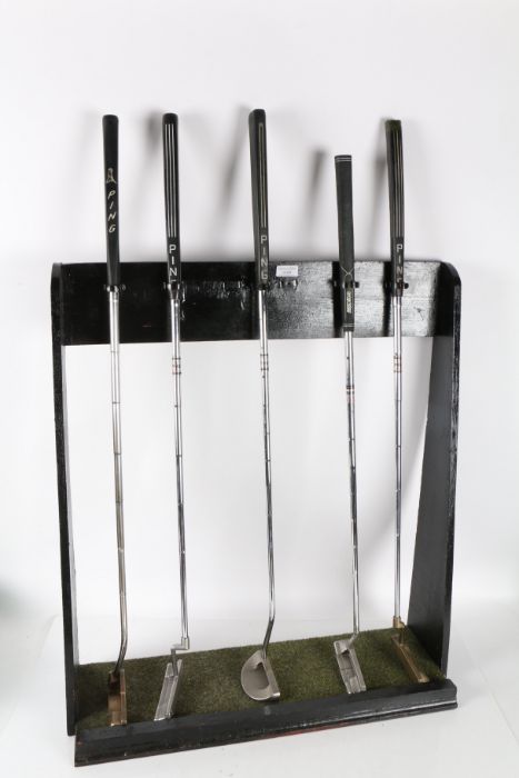 Five ping putters to include a left handed example, on a display stand (5)