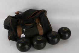 Four Almark bowling woods together with carrying case