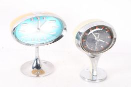 Two Coral mid 20th century desk clocks, both of ovoid form decorated with baton markers on a blue