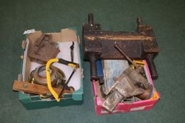 A collection of various tools to include socket set, spirit level, two vices etc housed within two