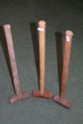 Three sledgehammers, all with wooden handles and iron heads