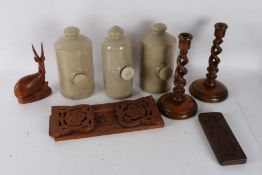 Three stoneware foot warmers, pair of oak barley twist candlesticks, oak barometer, hardwood book