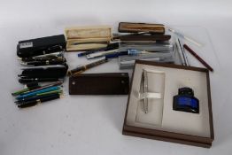 Collection of various pens, to include a Parker fountain in original box with bottle of ink, Cross