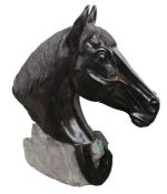Patinated sculpture of a Horse head, the head in black above a horse to the rocky plinth base,