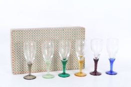 A set of six various coloured glasses with differing coloured stems housed within a box (6)