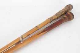 Two walking canes, the first a bamboo example, the second adapted from a cue (2)