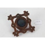 Victorian carved treen pocket watch stand, the square border with pierced holes and flower head