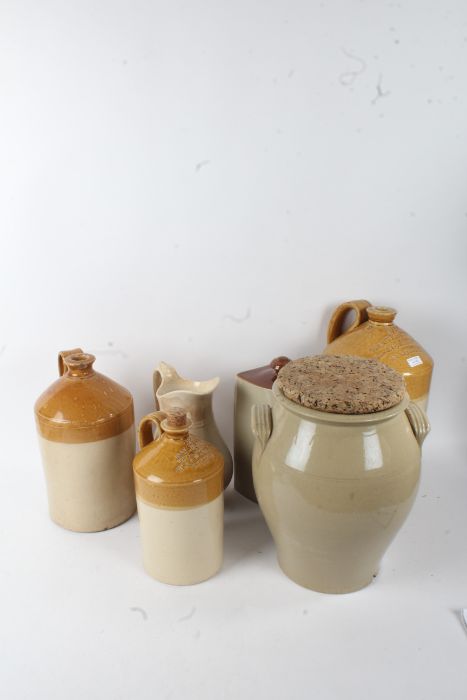 Five items of stoneware, to include a tall flagon impressed 'Walter Hicks Wine & Spirit Merchant