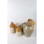 Five items of stoneware, to include a tall flagon impressed 'Walter Hicks Wine & Spirit Merchant