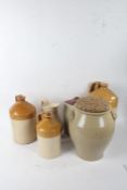 Five items of stoneware, to include a tall flagon impressed 'Walter Hicks Wine & Spirit Merchant