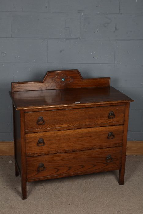 A 20th century chest of three long drawers, the rectangular top with a raised wooden gallery set