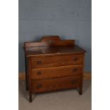 A 20th century chest of three long drawers, the rectangular top with a raised wooden gallery set