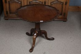 A George III mahogany occasional table, with a pie crust top above a turned pillar on tripod legs
