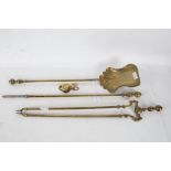 A brass companion set consisting of a poker, fire tongs and a shovel