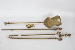 A brass companion set consisting of a poker, fire tongs and a shovel