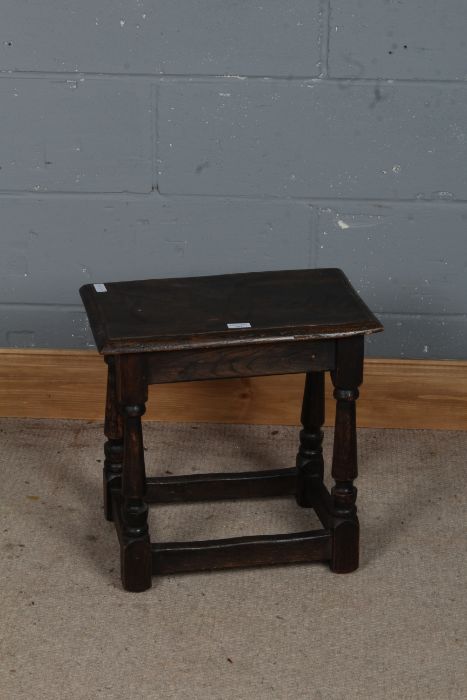 A 19th century oak joint stool, the rectangular top above tapering legs and stretchers, 46cm high
