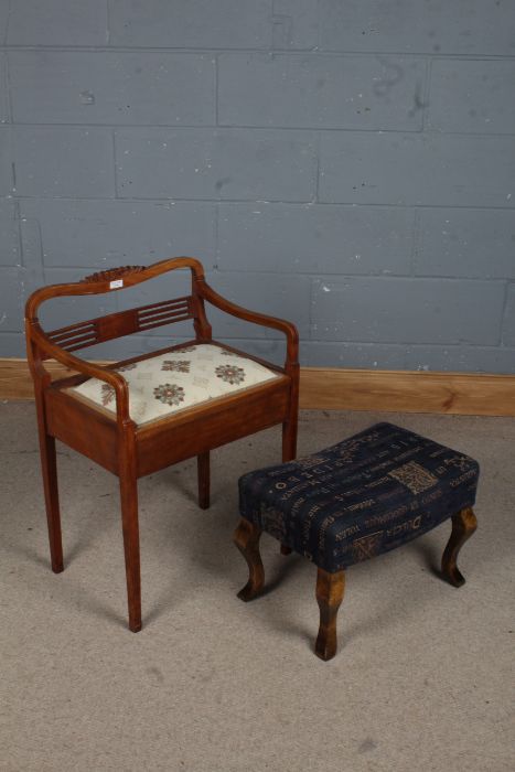 A 20th century piano stool with a pierced slat back and a upholstered seat opening to reveal storage