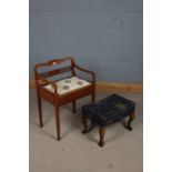 A 20th century piano stool with a pierced slat back and a upholstered seat opening to reveal storage