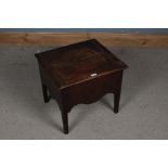 A 17th century style oak box stool, the top and side panels decorated with circular designs, the top