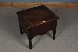 A 17th century style oak box stool, the top and side panels decorated with circular designs, the top