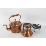 Victorian copper kettle, a Portugese copper kettle, and two metal trivet stands depicting dogs (4)