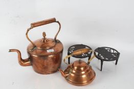 Victorian copper kettle, a Portugese copper kettle, and two metal trivet stands depicting dogs (4)