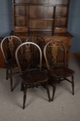 A set of five oak wheel and stick back dining chairs, 88cm high