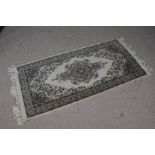 A Keshan rug, the cream ground with a central floral medallion together with multiple floral