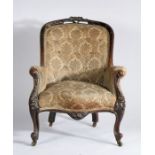Victorian mahogany armchair, the carved foliate top rail and button back above the serpentine