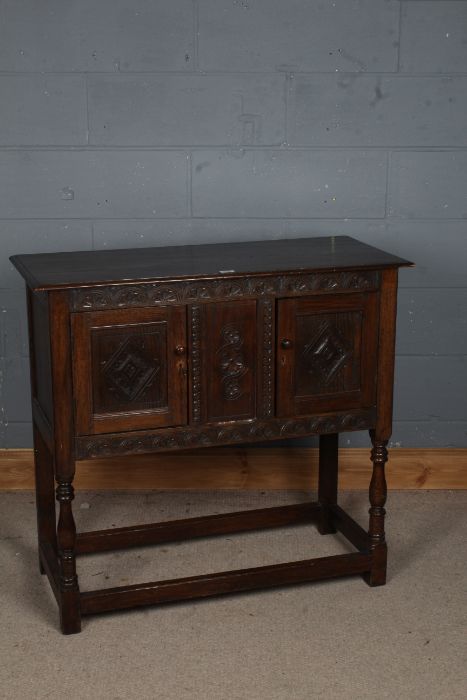 A 17th century style sideboard, the rectangular top above a flower filled carved lunette frieze,