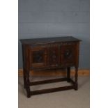 A 17th century style sideboard, the rectangular top above a flower filled carved lunette frieze,