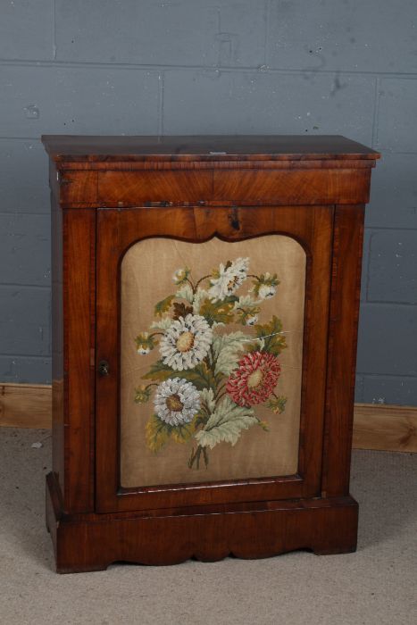 A Victorian style mahogany pier cabinet, the rectangular top above needle work and glazed front door