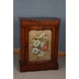 A Victorian style mahogany pier cabinet, the rectangular top above needle work and glazed front door