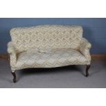 A 20th century upholstered sofa, with floral upholstery and a button back raised on cabriole legs,