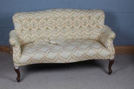 A 20th century upholstered sofa, with floral upholstery and a button back raised on cabriole legs,