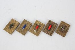 Five 20th century brass card cases all set with various stones and decorated with embossed floral