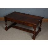 A 20th century oak coffee table, the rectangular top above baluster legs with stretchers,107cm