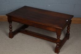 A 20th century oak coffee table, the rectangular top above baluster legs with stretchers,107cm