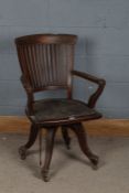 A 20th century mahogany desk chair, the top rail with boxwood inlaid and a inlaid diamond lozenge